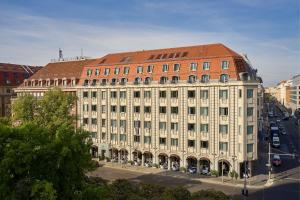 a large white building with a red roof at Hotel Luc, Autograph Collection in Berlin