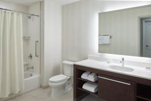 a bathroom with a sink and a toilet and a mirror at Residence Inn by Marriott Nashville Downtown/Convention Center in Nashville