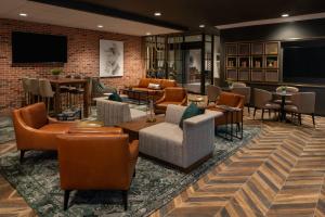 a lobby with couches and chairs and tables at New Orleans Marriott Warehouse Arts District in New Orleans