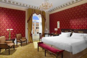 a bedroom with a large bed and red walls at The Westin Excelsior, Rome in Rome