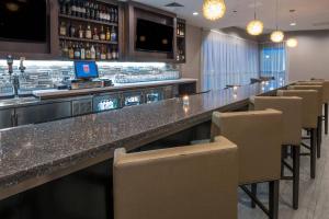 a bar in a restaurant with chairs and a counter at Residence Inn by Marriott Fishkill in Fishkill