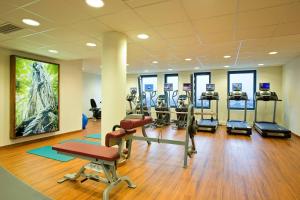 a gym with treadmills and machines in a room at Courtyard by Marriott Vienna Prater/Messe in Vienna