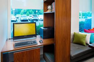 a computer sitting on a desk with a monitor and keyboard at Residence Inn by Marriott The Bronx at Metro Center Atrium in Bronx