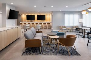 a lobby with a couch and chairs and tables at TownePlace Suites by Marriott West Kelowna in West Kelowna