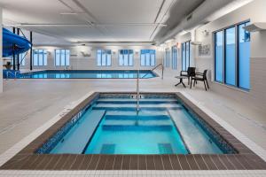 a pool in a building with a swimming pool at TownePlace Suites by Marriott West Kelowna in West Kelowna