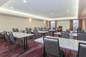 a conference room with white tables and chairs at Courtyard by Marriott Monroe Airport in Monroe