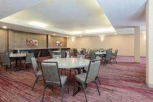 a conference room with tables and chairs in it at Courtyard by Marriott Monroe Airport in Monroe
