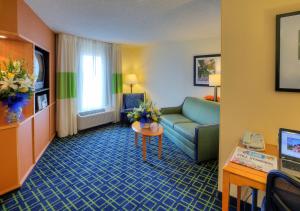 a hotel room with a couch and a table at Fairfield Inn & Suites Laredo in Laredo