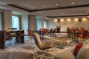 a meeting room with tables and chairs in a hotel at Washington Dulles Marriott Suites in Herndon