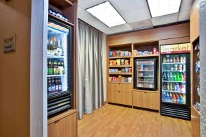 a drink aisle in a store with two refrigerators at SpringHill Suites Chicago Elmhurst/Oakbrook Area in Elmhurst
