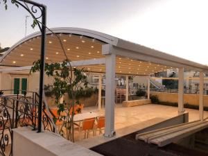 a pavilion with chairs and tables on a building at The Maltese Sun in Sliema