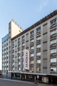 a building with a sign for a hotel at Jandaia Turismo Hotel in Santana do Livramento