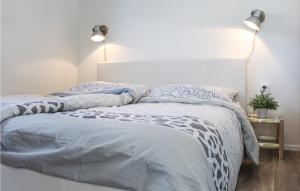 Schlafzimmer mit einem Bett mit blauer und weißer Bettwäsche in der Unterkunft Lovely Ship In Aalsmeer With Kitchen in Leimuiden