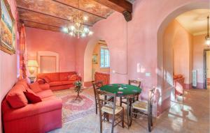 a living room with a red couch and a table at Villa Pieve, Lucignano in Lucignano