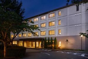 a large white building with a lot of windows at Fuji Marriott Hotel Lake Yamanaka in Yamanakako