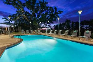 a large swimming pool with lounge chairs in a hotel at SpringHill Suites by Marriott Paso Robles Atascadero in Atascadero
