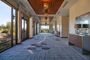 an empty hallway of a building with windows and a hallwayngth at SpringHill Suites by Marriott Paso Robles Atascadero in Atascadero