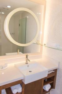 a bathroom with a white sink and a mirror at SpringHill Suites by Marriott Sumter in Sumter