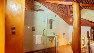 La salle de bains est pourvue d'une douche en verre et d'un lavabo. dans l'établissement Trois Ore Residences & Green Earth Bistro, à Ibadan