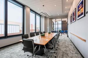 uma sala de conferências com uma mesa longa e cadeiras em SpringHill Suites Madison em Madison