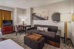 a living room with a couch and a tv at SpringHill Suites by Marriott Norfolk Virginia Beach in Virginia Beach +33 photos