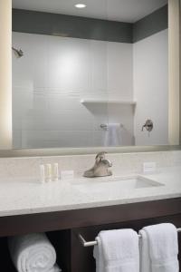 a bathroom with a sink and a mirror and towels at Residence Inn by Marriott Denver Southwest/Littleton in Littleton