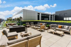 a patio with couches and tables on a building at AC Hotel by Marriott Washington DC Downtown in Washington