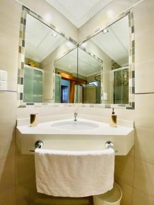 a bathroom with a sink and a large mirror at Peace and View Apartment Puerto Rico in Puerto Rico de Gran Canaria