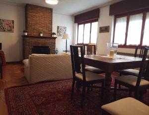 a living room with a table and a couch at Casa Vasca in Llanes