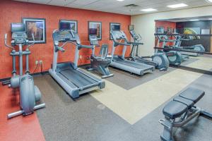 a gym with rows of tread machines and mirrors at Courtyard Fargo Moorhead, MN in Moorhead