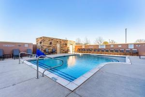 a large swimming pool with chairs around it at Fairfield Inn & Suites Dallas Arlington South in Arlington