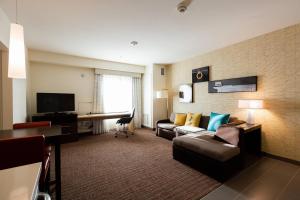 a hotel room with a couch and a desk at Residence Inn by Marriott Oklahoma City North/Quail Springs in Oklahoma City