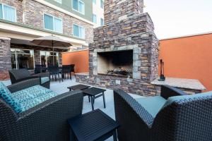 a patio with a fireplace and chairs and tables at Residence Inn by Marriott Oklahoma City North/Quail Springs in Oklahoma City