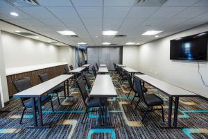 a conference room with tables and chairs and a flat screen tv at Residence Inn by Marriott Oklahoma City North/Quail Springs in Oklahoma City