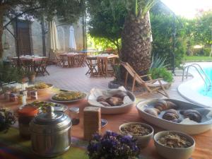 a table with bowls of food next to a pool at Palazzo Conforti Tree House Resort in Marano Marchesato