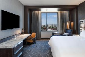 a hotel room with a large bed and a large window at Renaissance Oklahoma City Downtown Bricktown Hotel in Oklahoma City