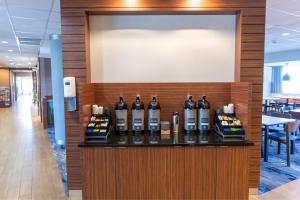 a display of wine bottles on a counter in a restaurant at Fairfield Inn & Suites by Marriott Athens I-65 in Athens
