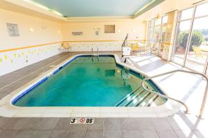 a large swimming pool in a large building with a large window at Fairfield Inn & Suites by Marriott Athens I-65 in Athens