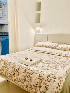 a bed with a tray with two donuts on it at Peace and View Apartment Puerto Rico in Puerto Rico de Gran Canaria