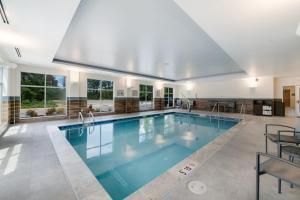 a large swimming pool with blue water in a house at Fairfield by Marriott Inn & Suites Virginia Beach Town Center in Virginia Beach