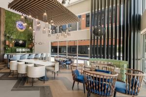 a restaurant with chairs and tables and a large organ at Fairfield by Marriott Inn & Suites Virginia Beach Town Center in Virginia Beach