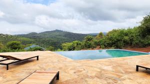 a swimming pool with a view of a mountain at Pembeni Rhotia in Karatu