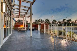 an outdoor deck with a fire pit on a house at SpringHill Suites by Marriott Gulfport I-10 in Gulfport