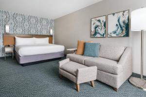 a hotel room with a bed and a couch at Courtyard by Marriott Orlando Downtown in Orlando