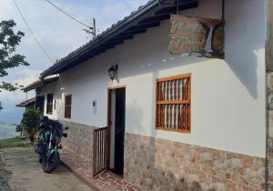 a motorcycle parked in front of a house at Hostal posada San jose in San José de Suaita