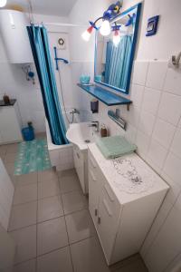 a bathroom with a sink and a mirror and a shower at Vista del Sal in Portorož