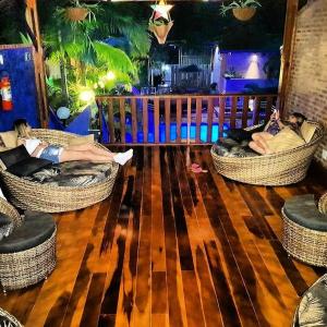 two people laying in wicker chairs on a wooden floor at Hotel Natural Brotas - SPA & Lazer in Brotas