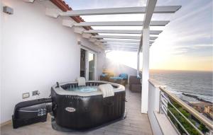 a hot tub on a balcony with the ocean at Attico Eleonora in Castelsardo +19 photos