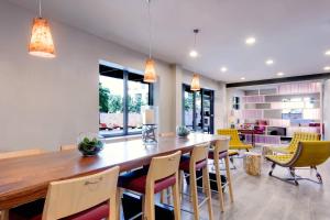 a dining room with a large wooden table and chairs at Fairfield Inn & Suites by Marriott Charlotte Uptown in Charlotte