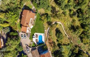 an overhead view of a house with a blue pool at Nice Home In Lovran With Sauna in Lovran +50 photos